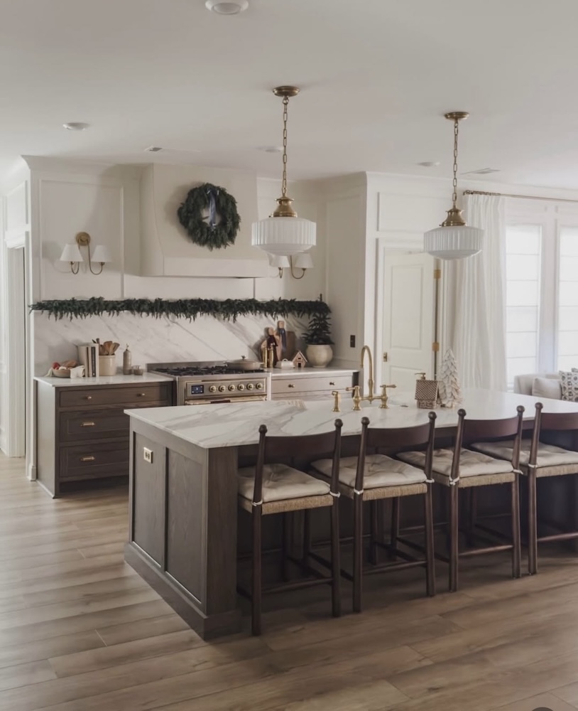 Renovated kitchen with dark island, pendant lights and open shelving by Ace Estates
