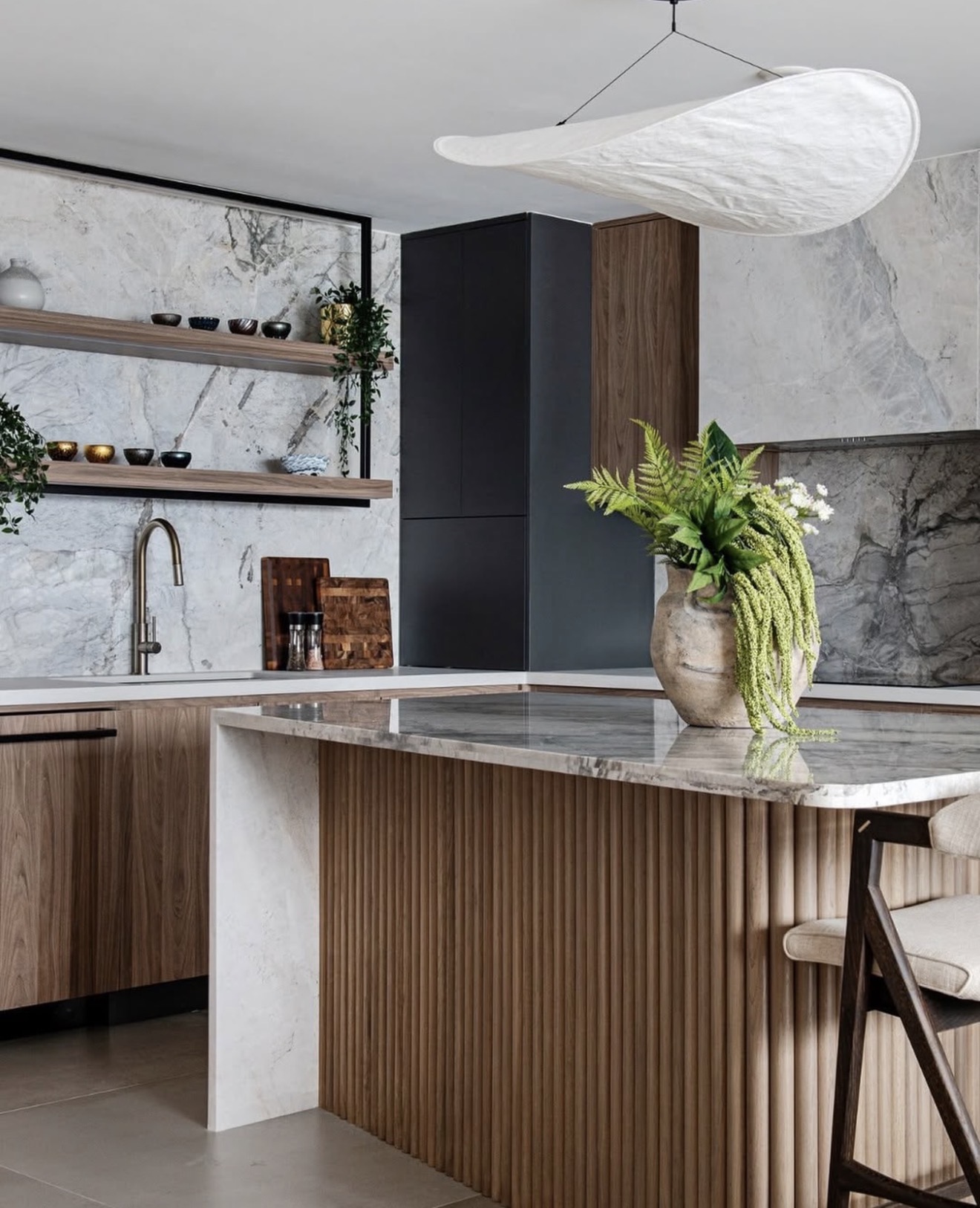 Whole-home renovation detail with fluted island and stone counters by Ace Estates