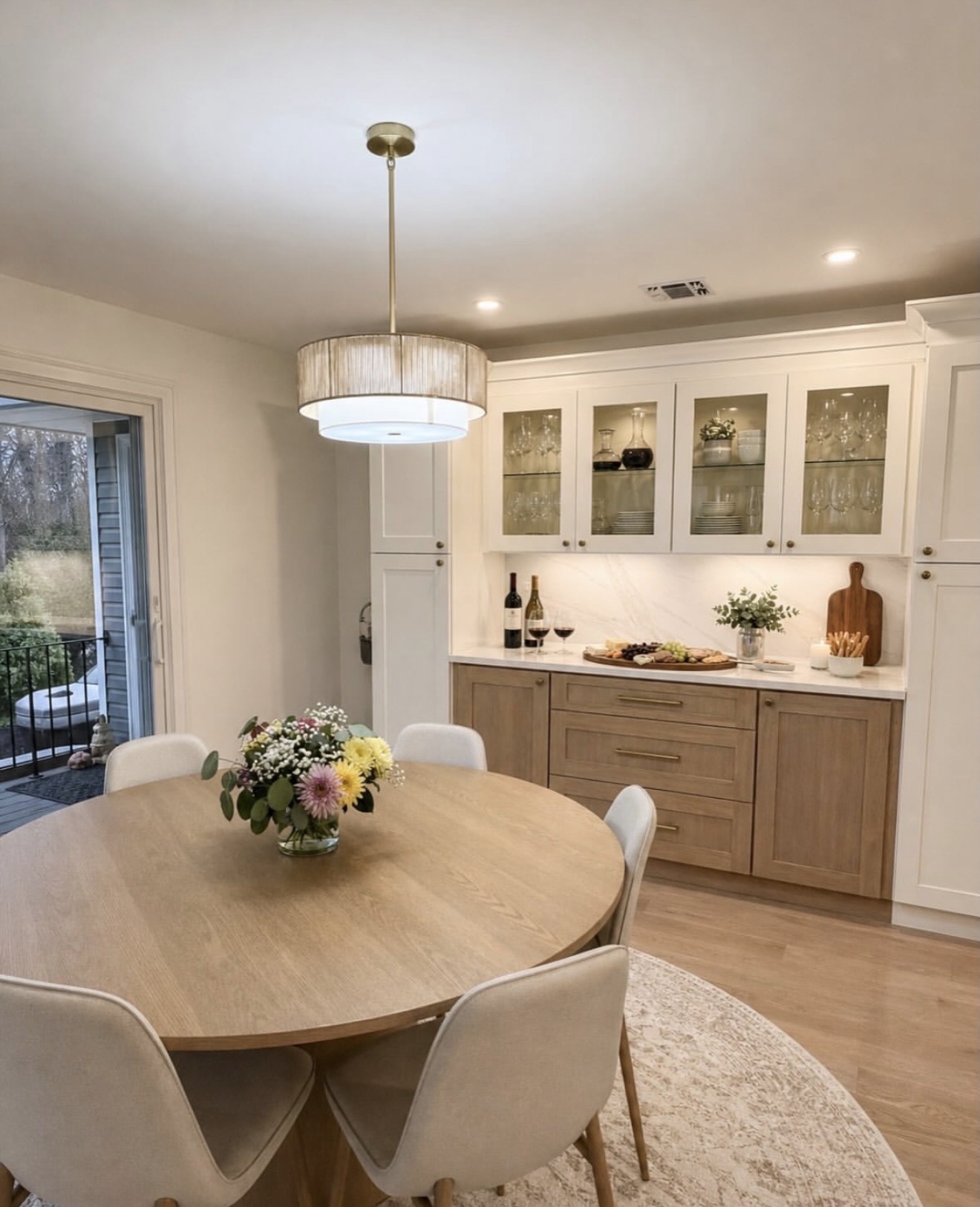 Remodeled kitchen and dining area with pendant lighting by Ace Estates