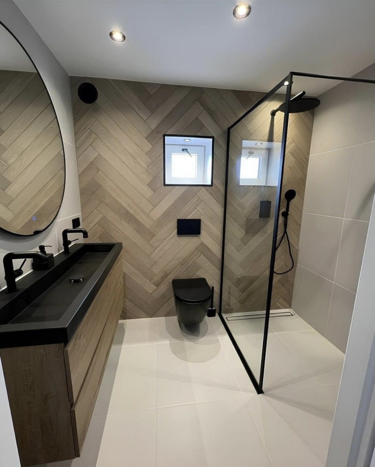 Bathroom remodel by Ace Estates with walk-in glass shower and herringbone wood-look tile